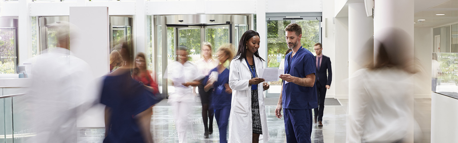heathcare professionals, standing together in a bright space