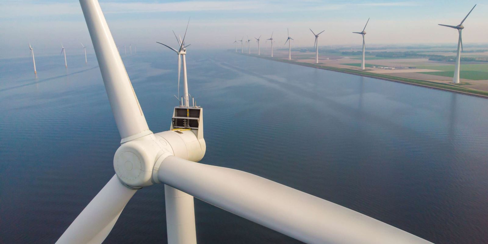 A view of wind turbines against a blue sky